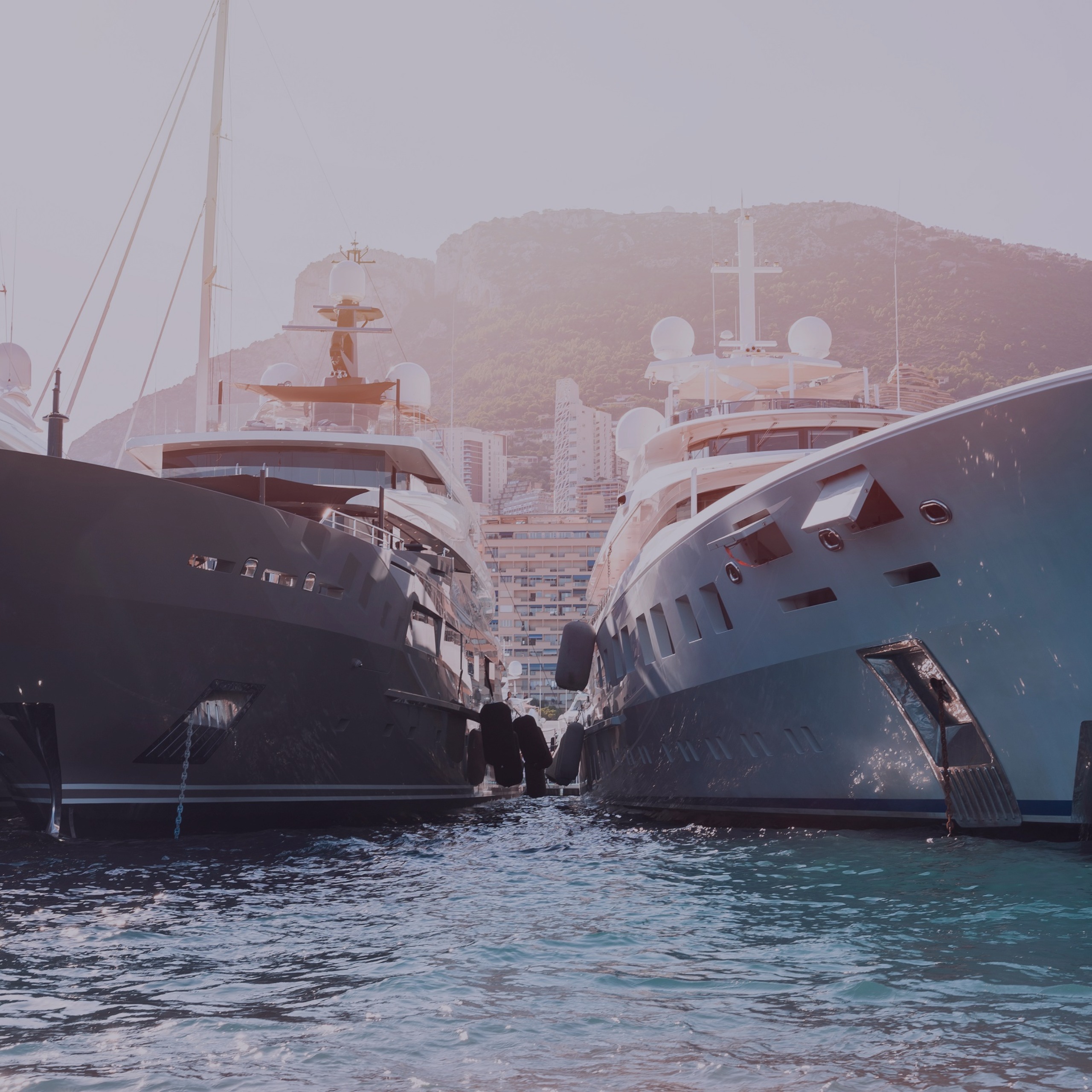 Two big yachts next to each other in the dock